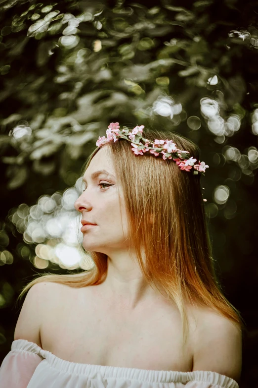 the woman with the flowers in her hair is looking away