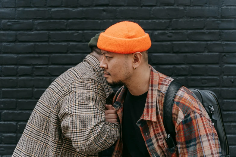 two men on the street one wearing a beanie