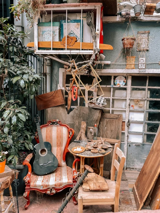 the back side of a house with a variety of junk on the patio