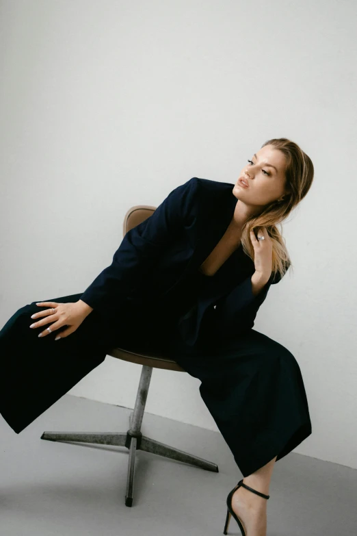 a woman leaning up on top of a chair