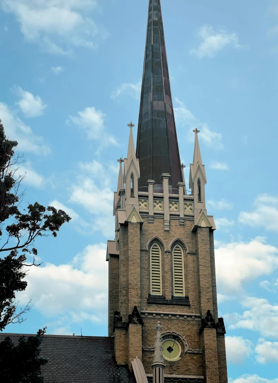 a large tower with a clock and a sky background