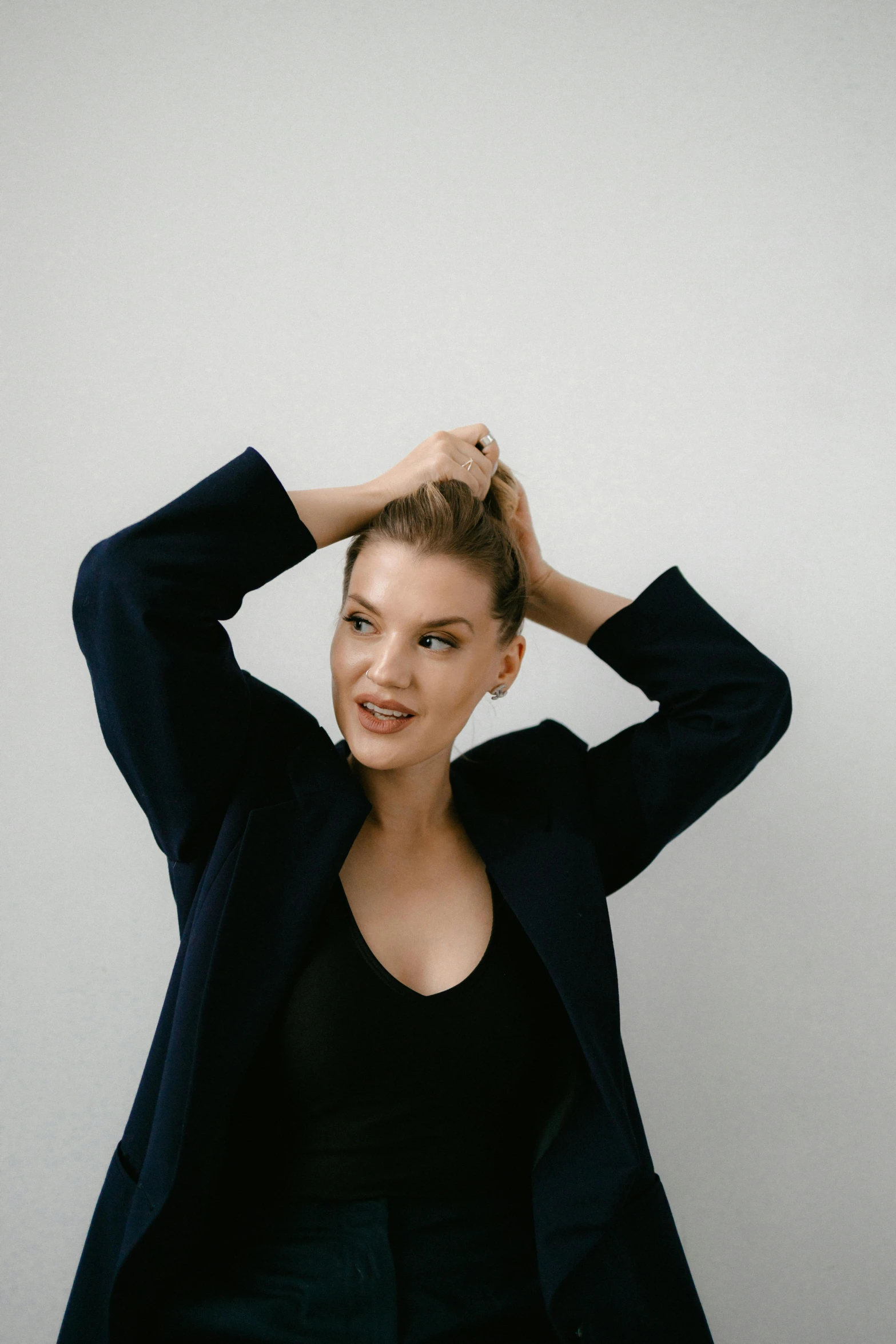 an image of a woman putting her hair up