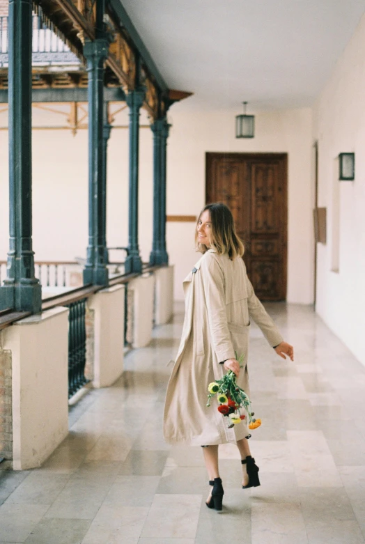 a woman in heels walking through a hallway