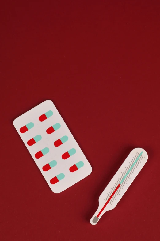 an open white plastic thermometer with a red background