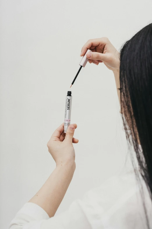 a close up of a person holding an electric toothbrush