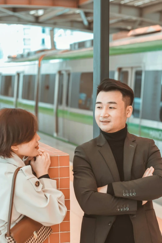 an asian man and woman in the station