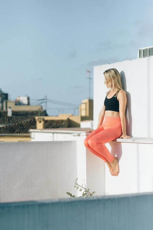 a woman with her feet on the side of a building