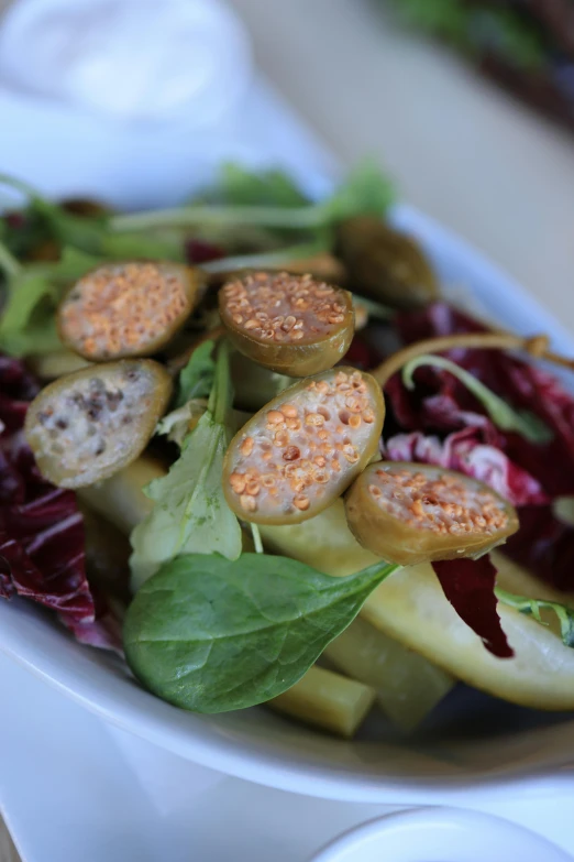 a salad with meat, potatoes and leaves