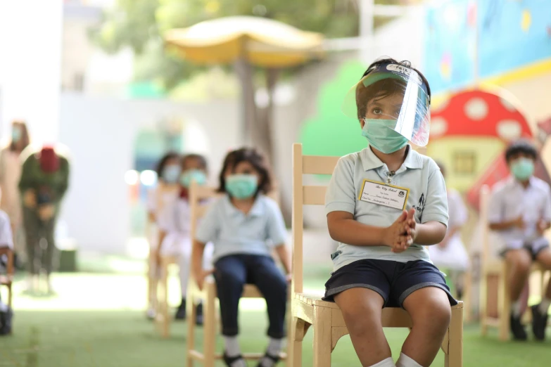 a group of young children wearing face masks