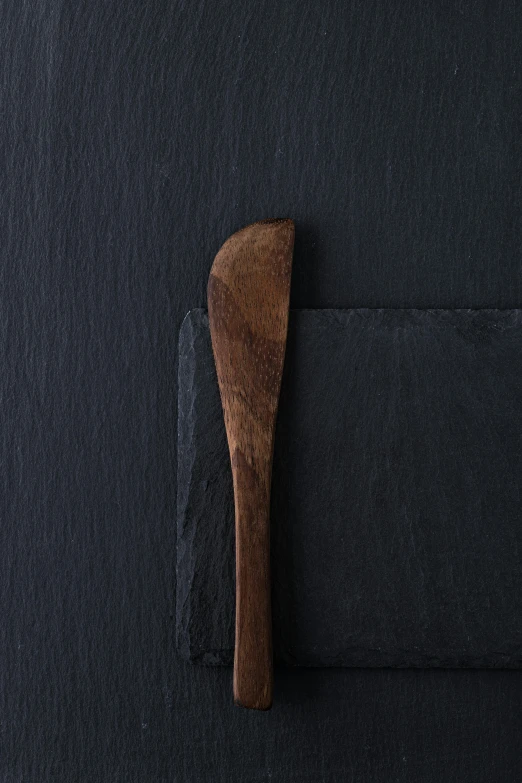 an open cloth covered wooden spoon resting on a piece of fabric