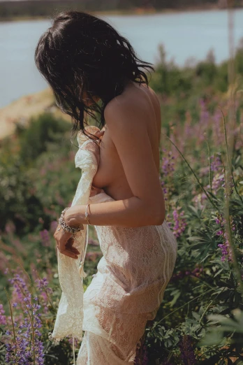 a woman walking through flowers with long hair