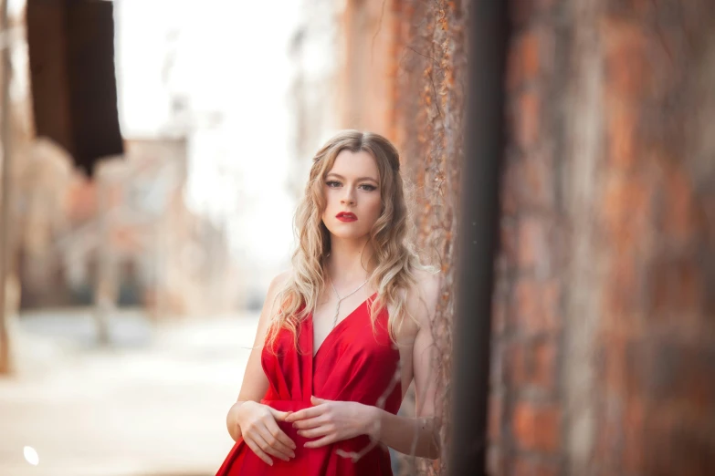 a girl with blonde hair wearing a red dress