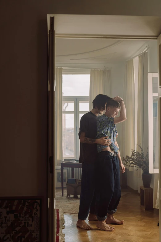 a young couple is posing in their home