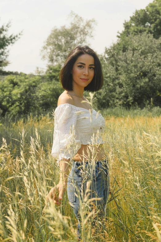 an asian woman is in the tall grass