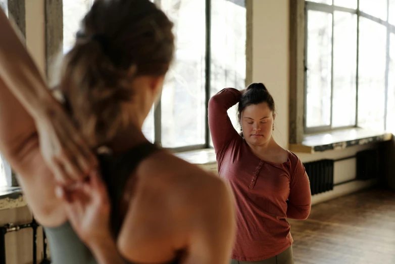 the woman in green top is stretching her arms