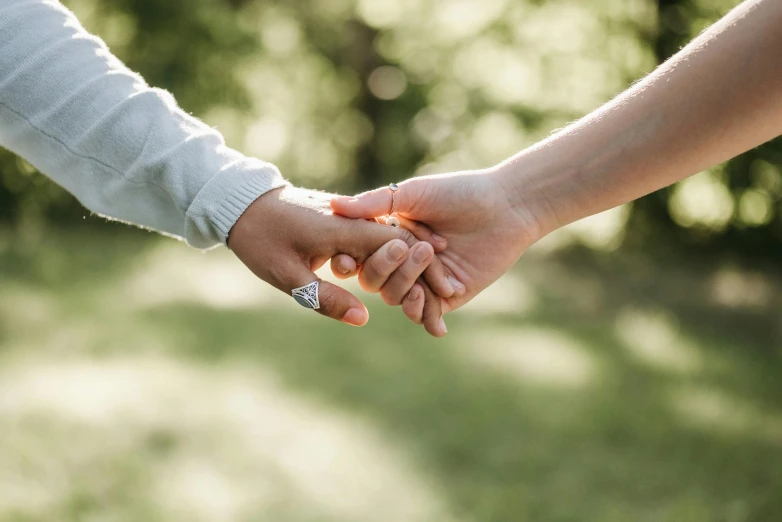 a couple holding hands, holding each other