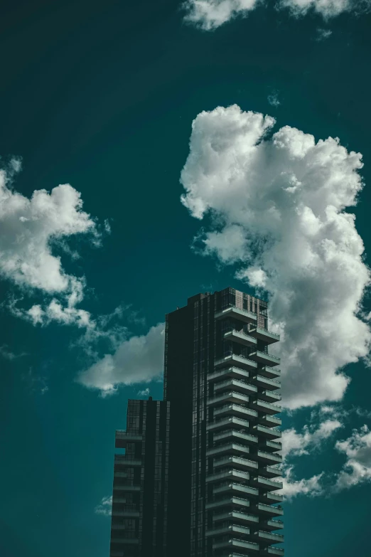 clouds moving in to overcast skies over a high rise building