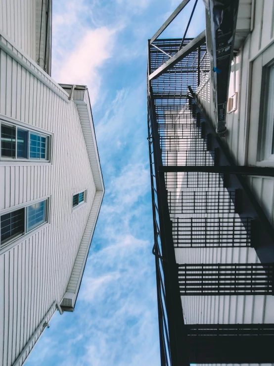 looking up at two buildings from the ground