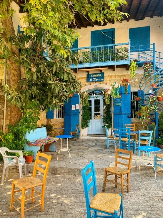 a patio with a bunch of blue and white chairs