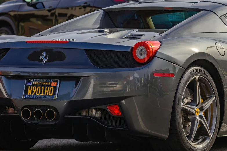 grey ferrari sports car parked in front of a motorcycle