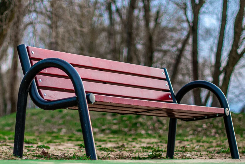 a park bench is in the middle of a field