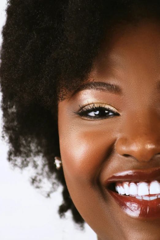 a woman smiles while she has natural hair