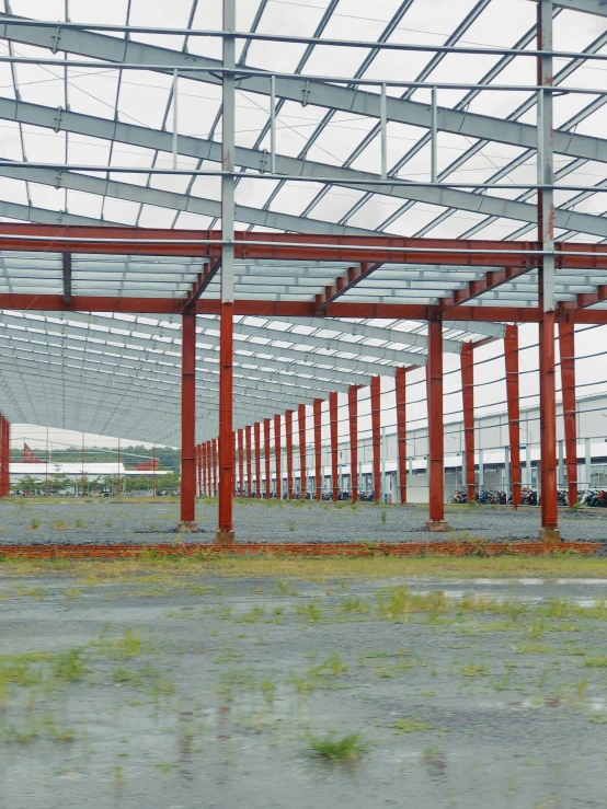 the inside of an industrial warehouse that has red pipe structures