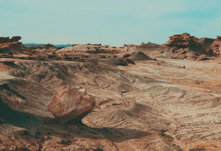 a large rock in a dirt mountain area