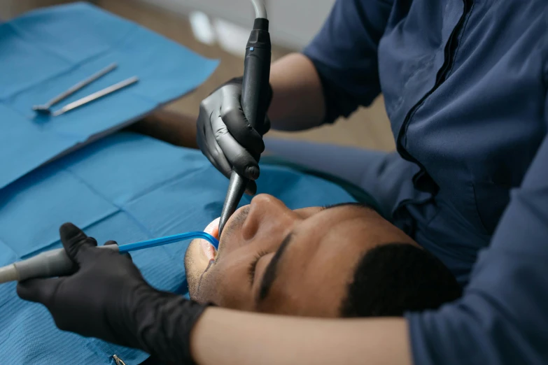 a doctor doing  on a man's head