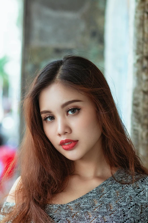 a beautiful woman standing in the street with red hair