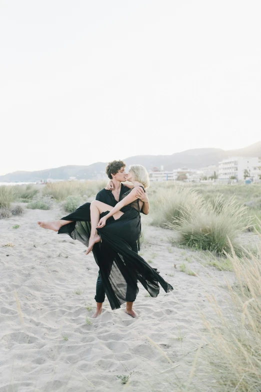 a woman and man emce on the beach