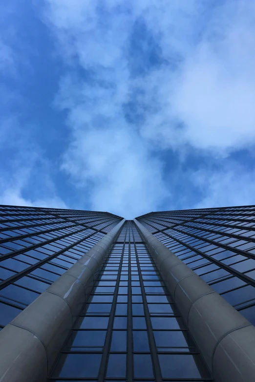 a high rise building looks upward into the sky