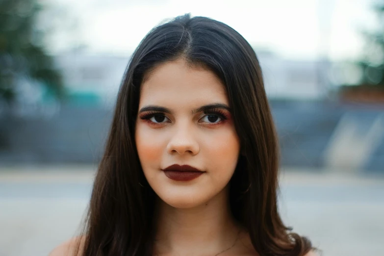 a girl with dark lipstick is posing for a po