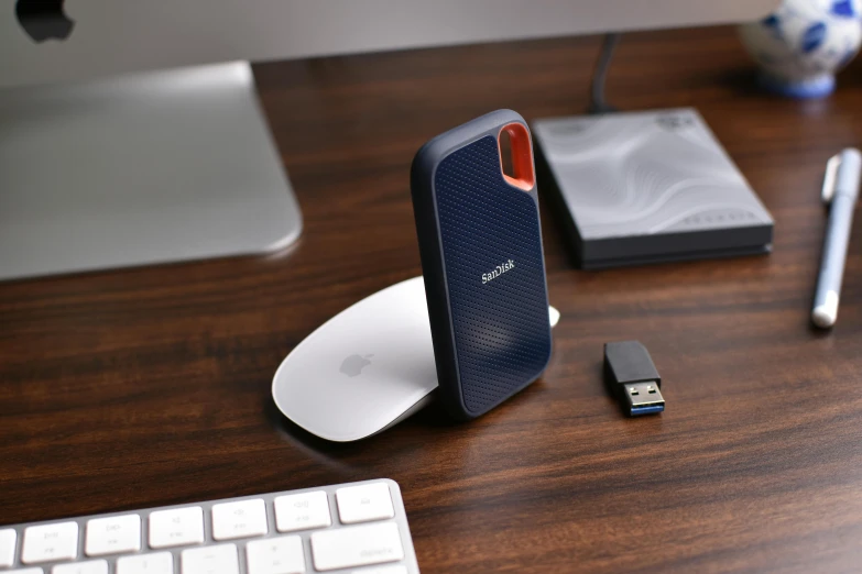 a computer is sitting on the desk near a laptop