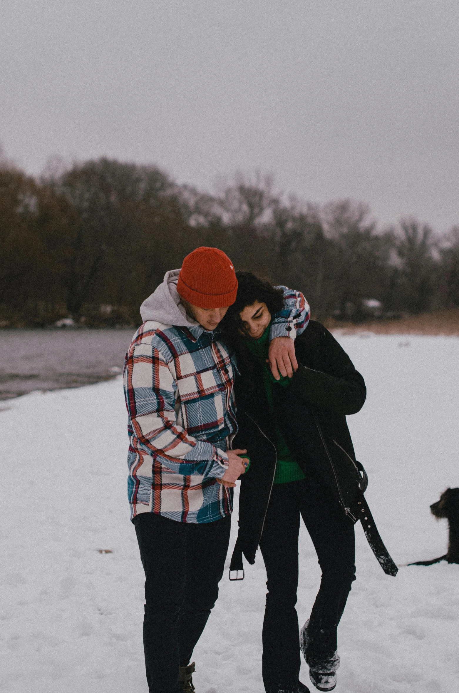 two people standing next to each other in the snow