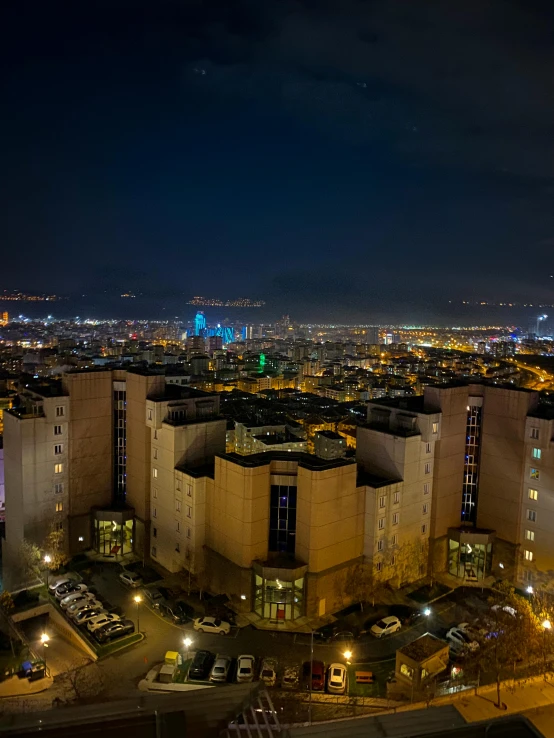 a view of some tall buildings at night