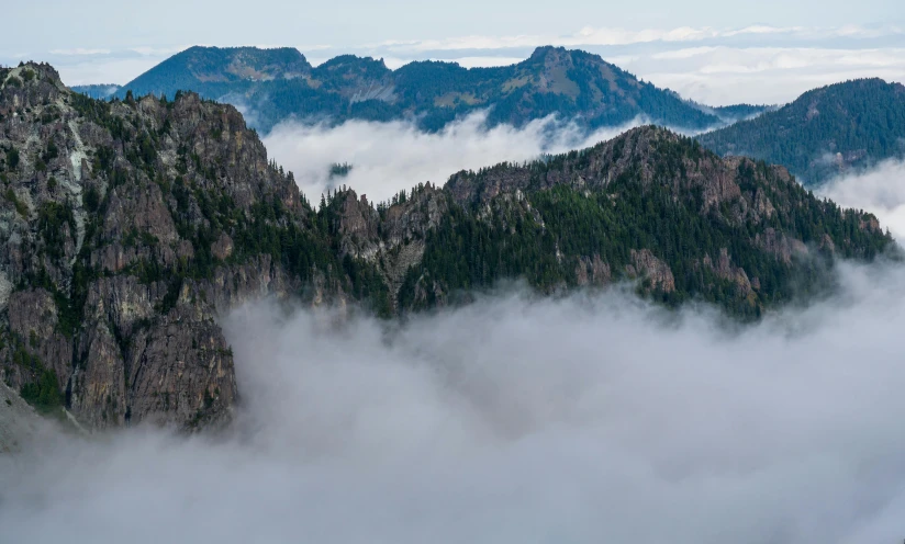 an airplane is flying over the top of some mountains