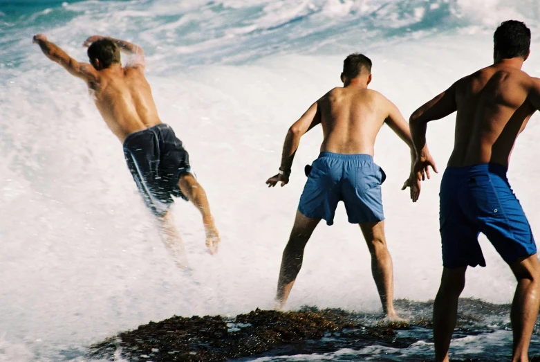 the men are playing in the ocean waves