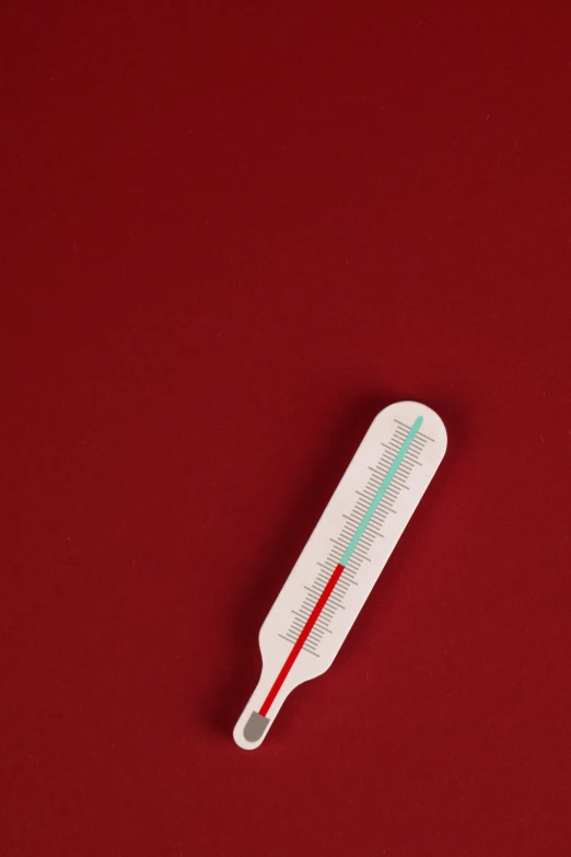 a thermometer that has been placed on a red table