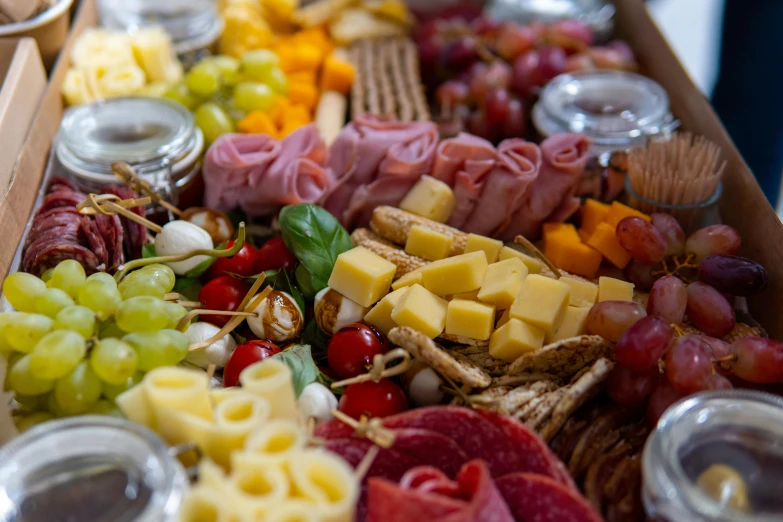 different kinds of assorted cheeses and other treats