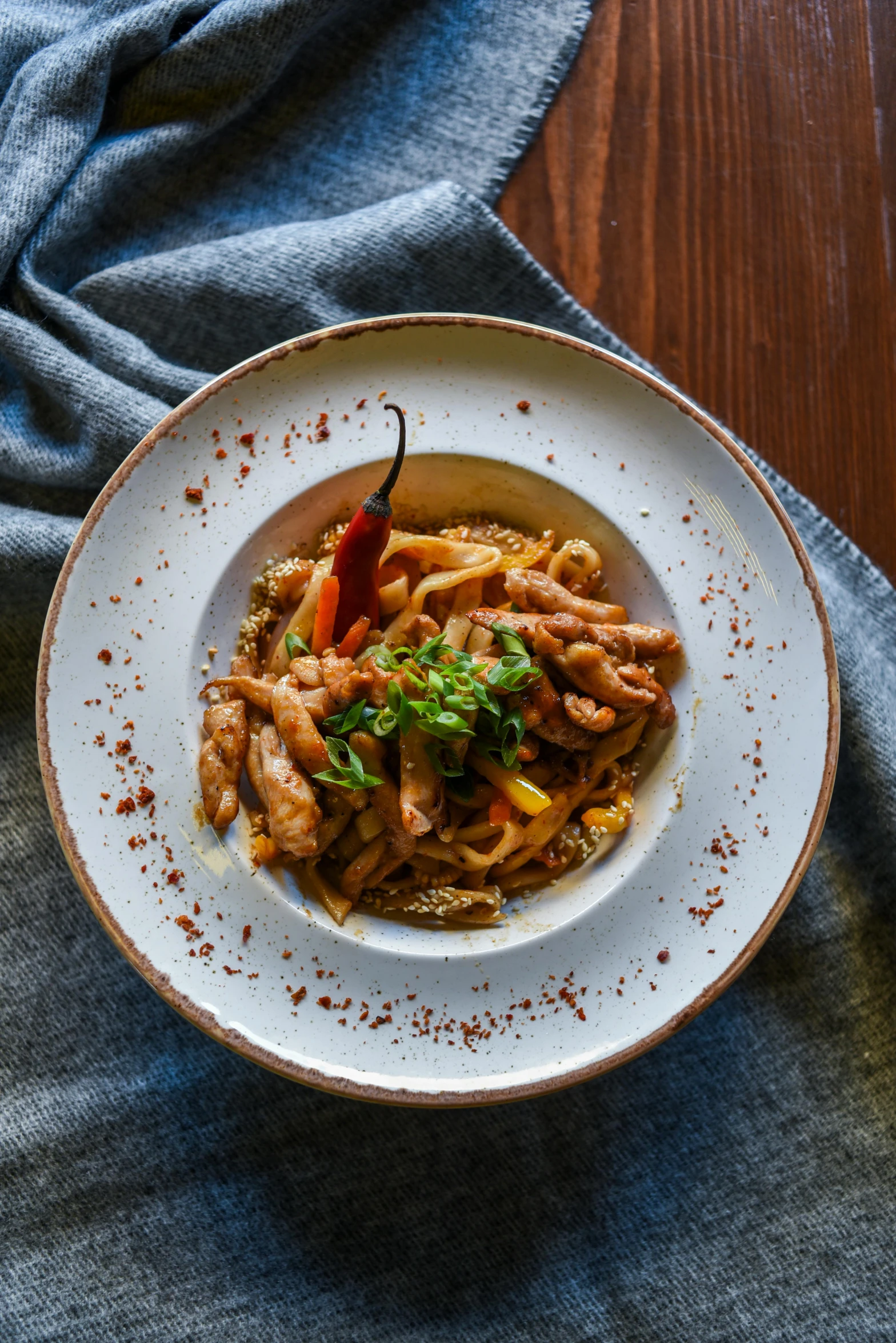 a small white bowl filled with food next to a cloth