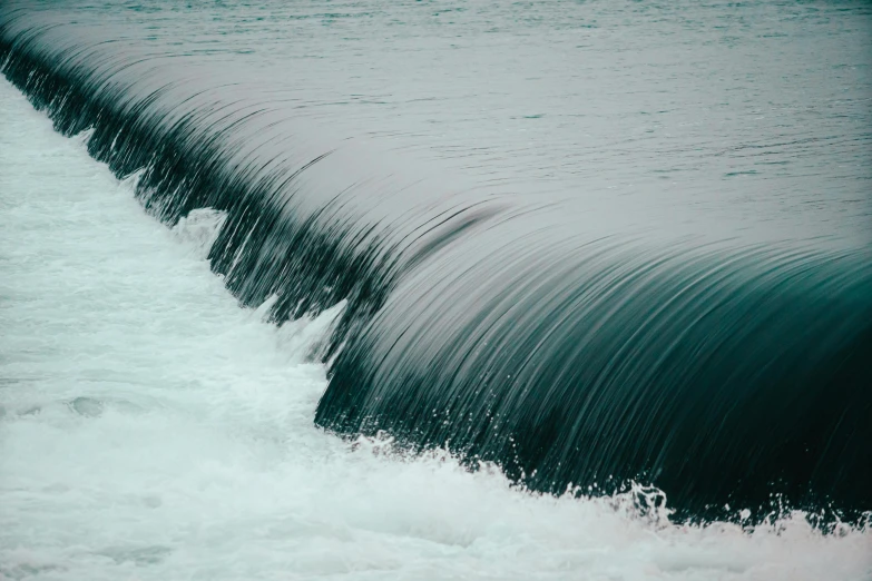 a wave coming up from the sea by some kind of pipe