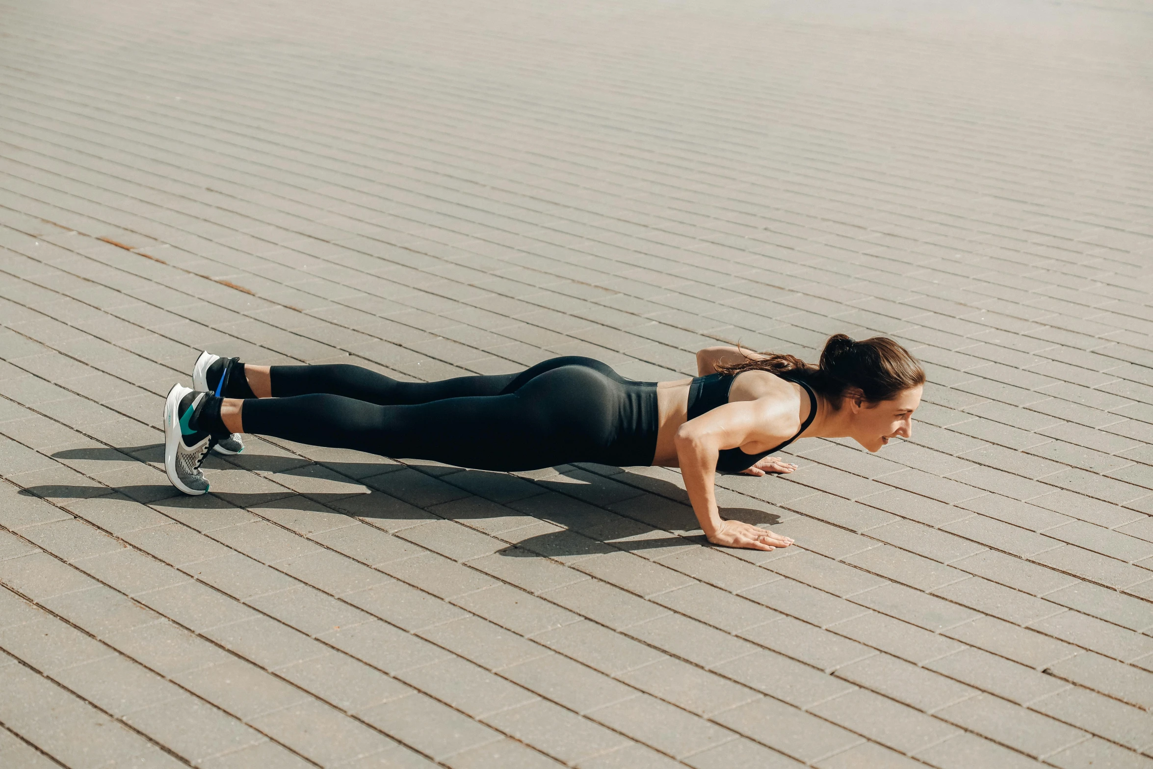 woman doing h up while laying on the ground