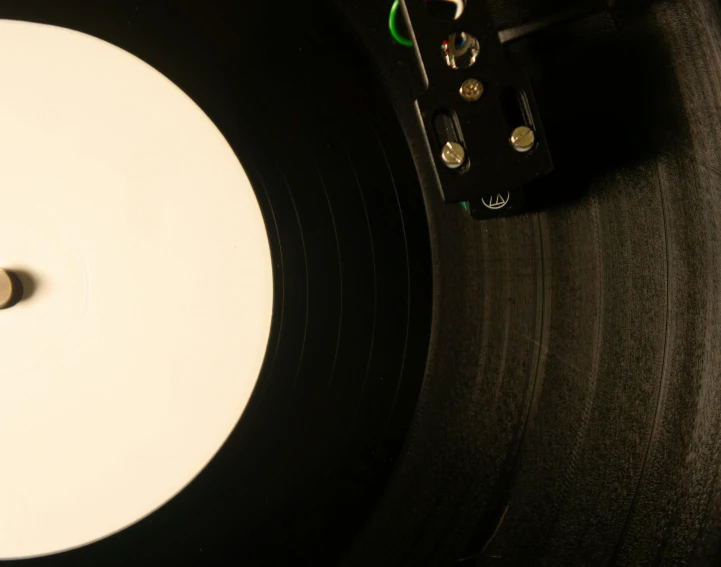 closeup view of the white vinyl record with black disk