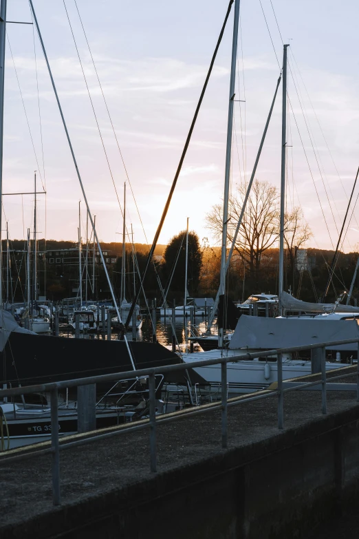 many boats sitting next to each other on a river