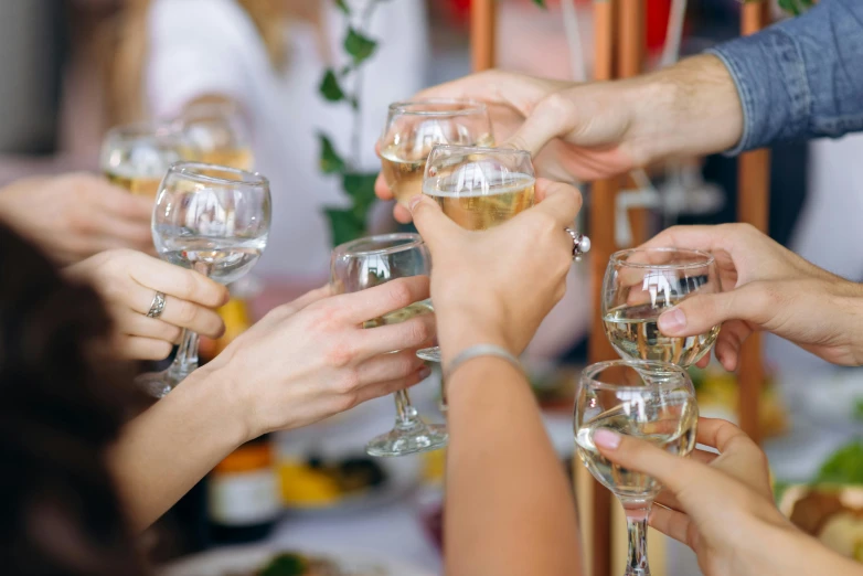 the people are enjoying their time together holding glasses of wine