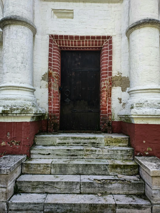 a large black door sitting on top of a brick building