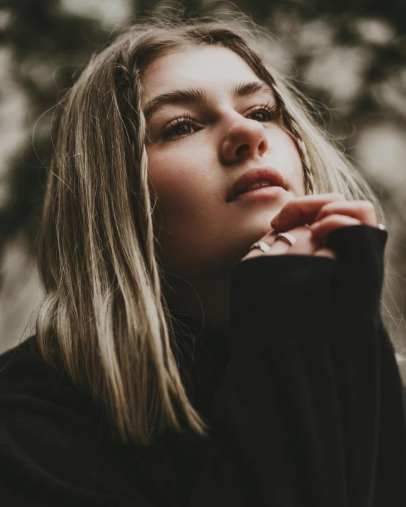 a girl in the woods with long blond hair