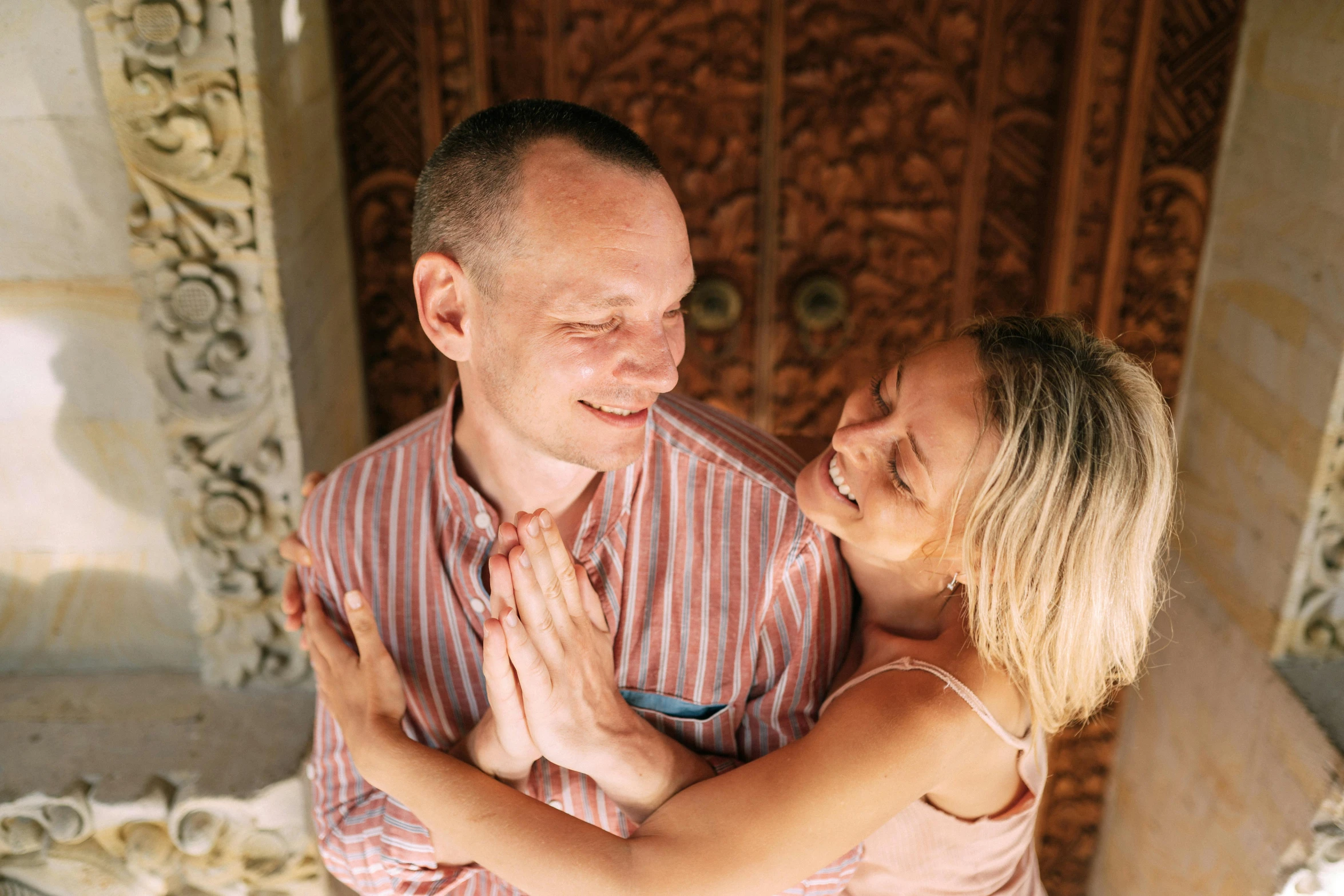 two people smiling and hugging with each other