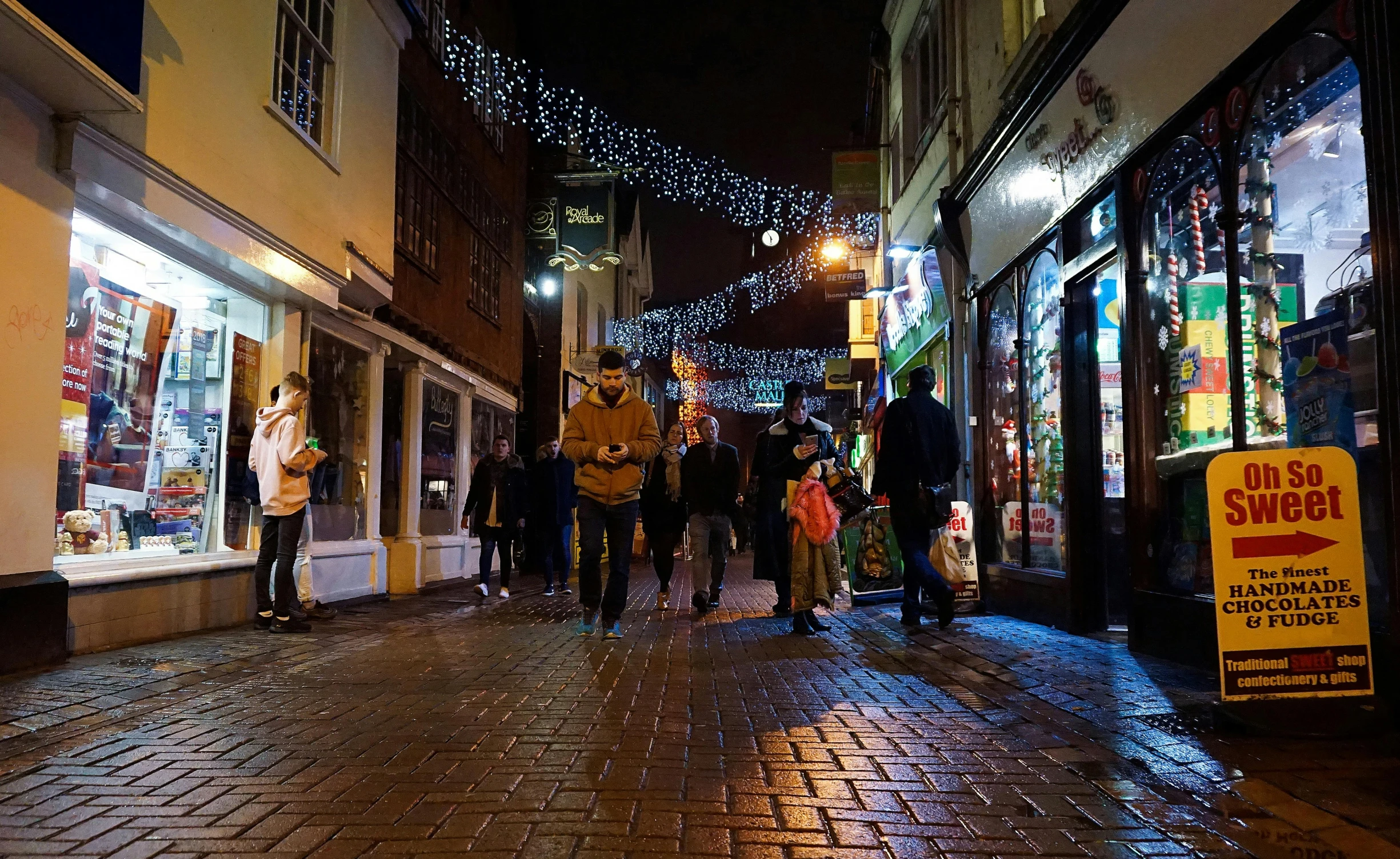 a city street with people walking through it